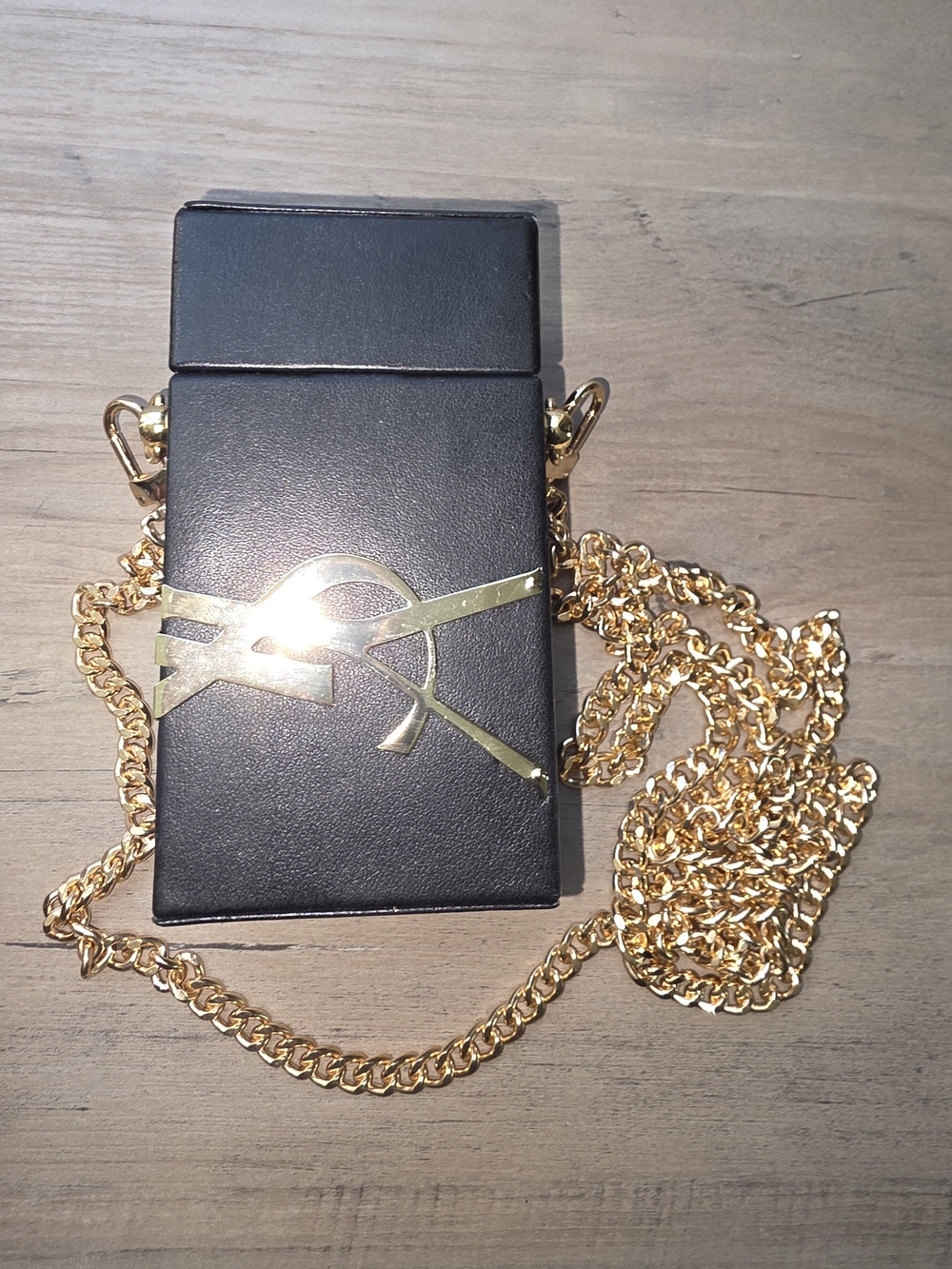 GWP Black Crossbody Case with Gold Chain and Decorative Emblem